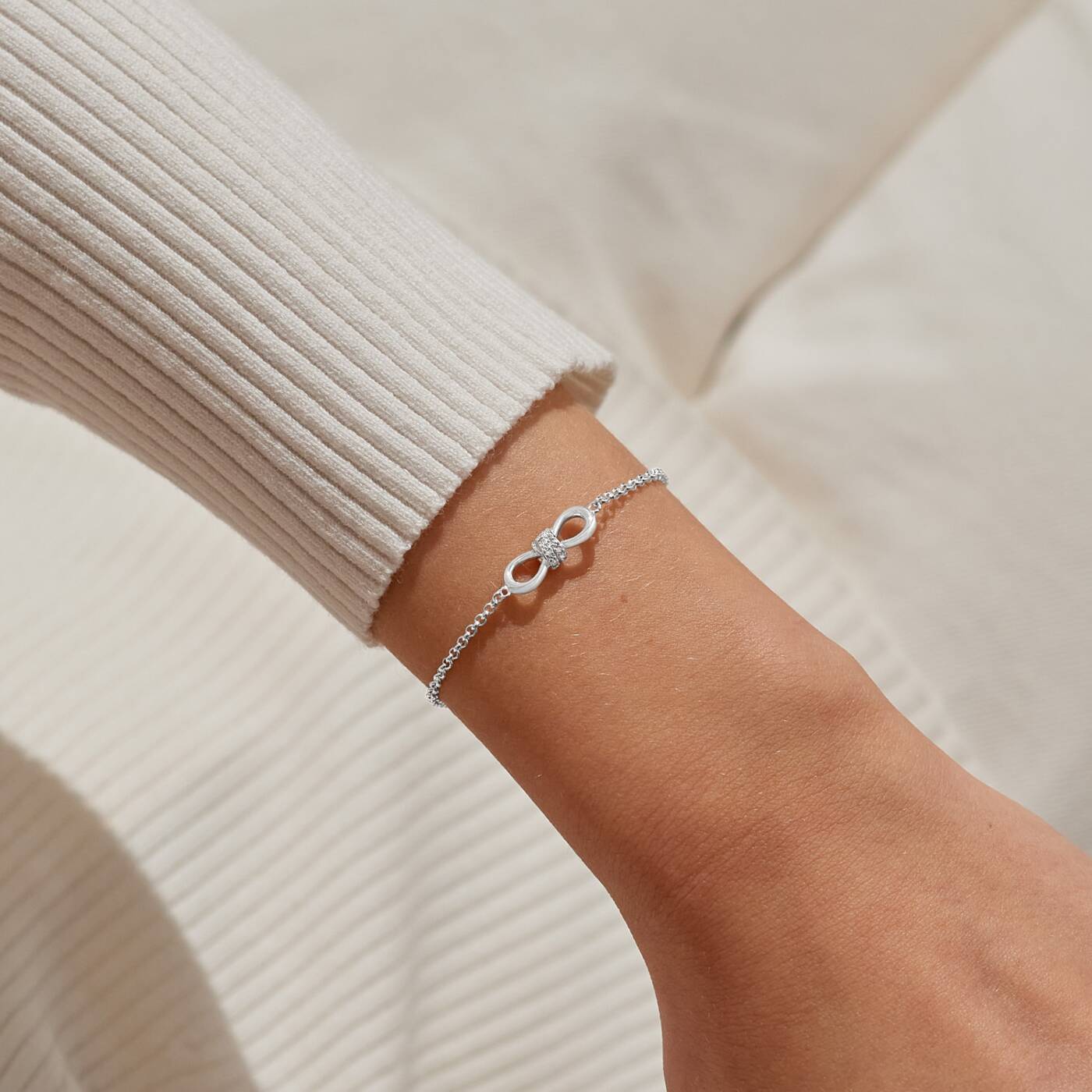 A LITTLES & CO Evermore Infinity Knot bracelet in silver with a sleek, polished finish on a white background.