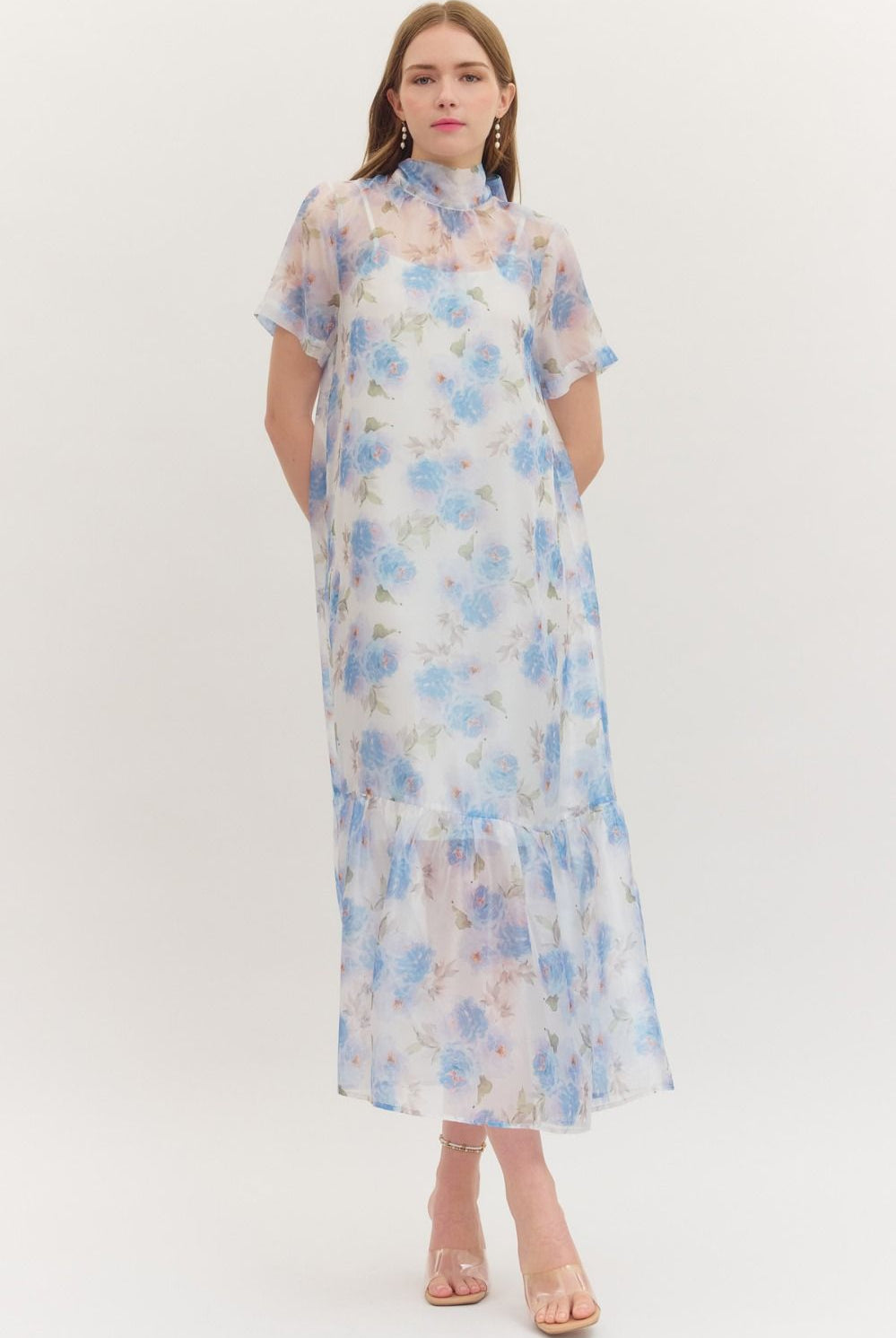 ENTRO Ollie floral printed short sleeve midi dress displayed on a hanger, showcasing its vibrant floral pattern and elegant design.