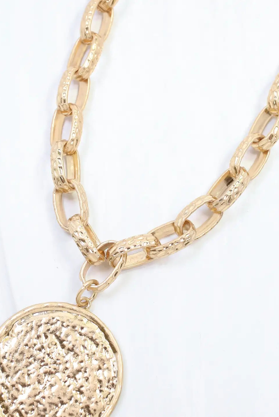 Caroline Hill Newcastle textured medallion necklace featuring a detailed pendant on a chain, stylish jewelry for everyday wear.