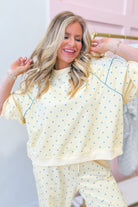 Frederick yellow polka dot pullover sweatshirt by PEACH LOVE with long sleeves and ribbed cuffs on a plain background.