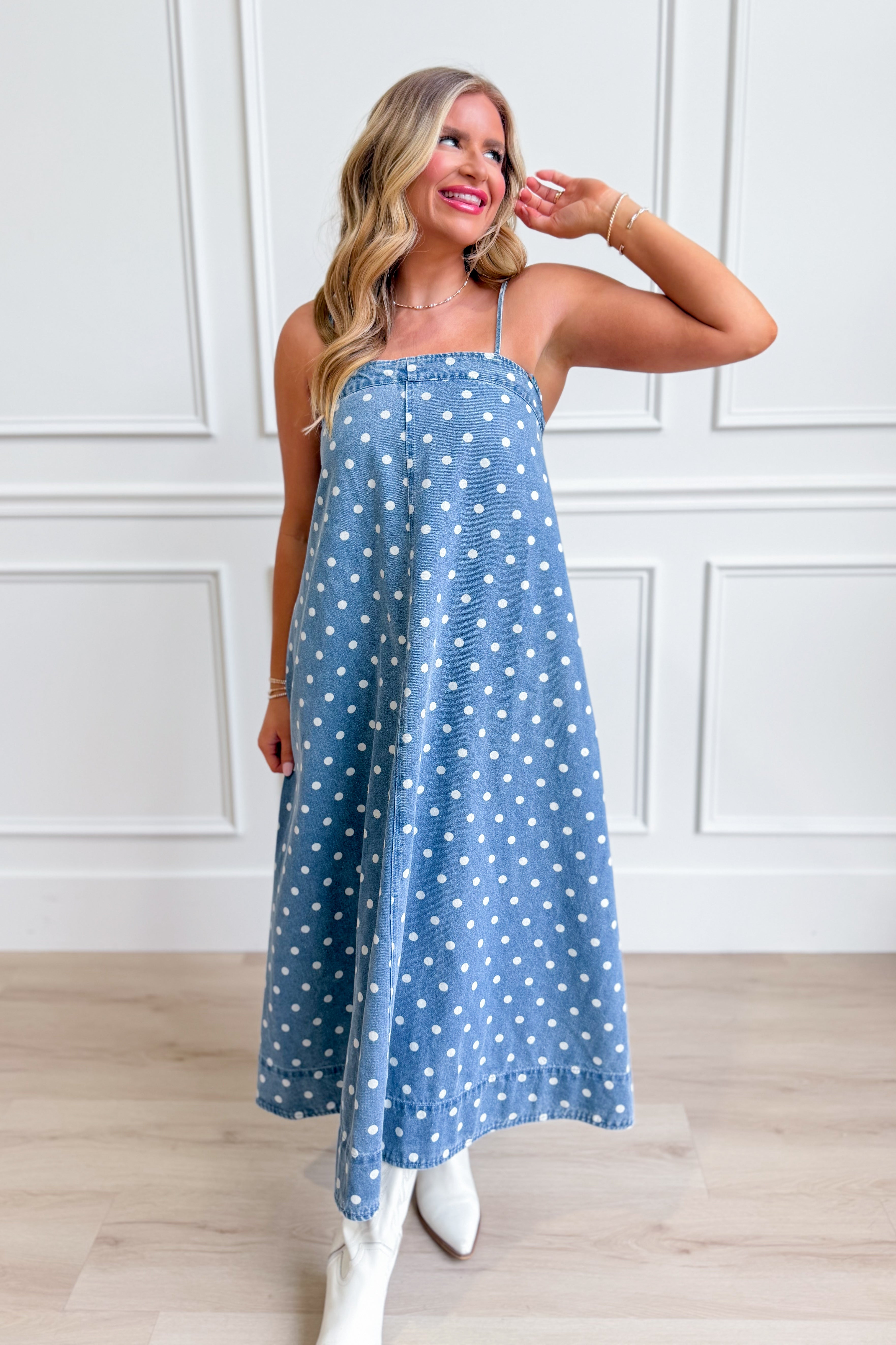 Aureum Mia polka dot denim dress with a fitted bodice and flared skirt, featuring classic polka dot pattern and sleeveless design.