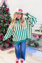Green reversible sweatshirt with red and white striped and Merry graphic design from PEACH LOVE's 137 Graphic Sweatshirts collection.
