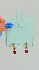 Enewton .5mm classic birthstone huggie earrings featuring small, sparkling gemstones in a silver-tone metal setting.
