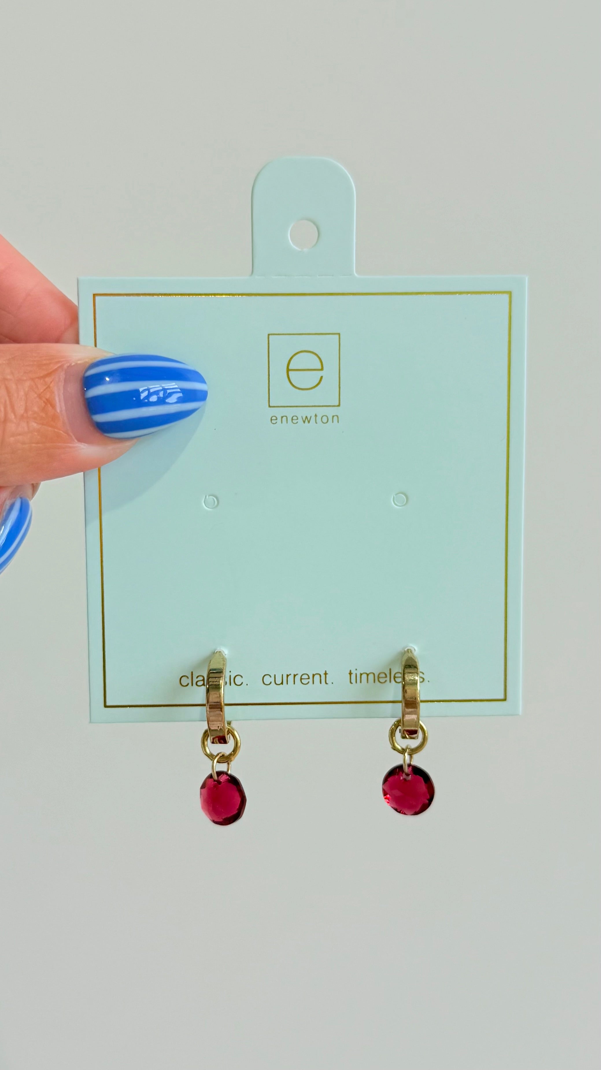 Enewton .5mm classic birthstone huggie earrings featuring small, sparkling gemstones in a silver-tone metal setting.