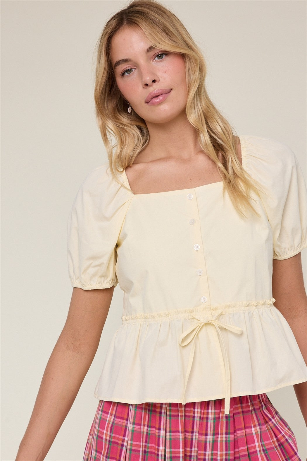 WISHLIST Hayden Butter peplum puff sleeve top in yellow, featuring a fitted bodice and stylish puff sleeves.