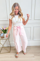 Light pink mineral washed PEACH LOVE Candice barrel jeans with eyelet details, 147 novelty denim for a stylish casual look.