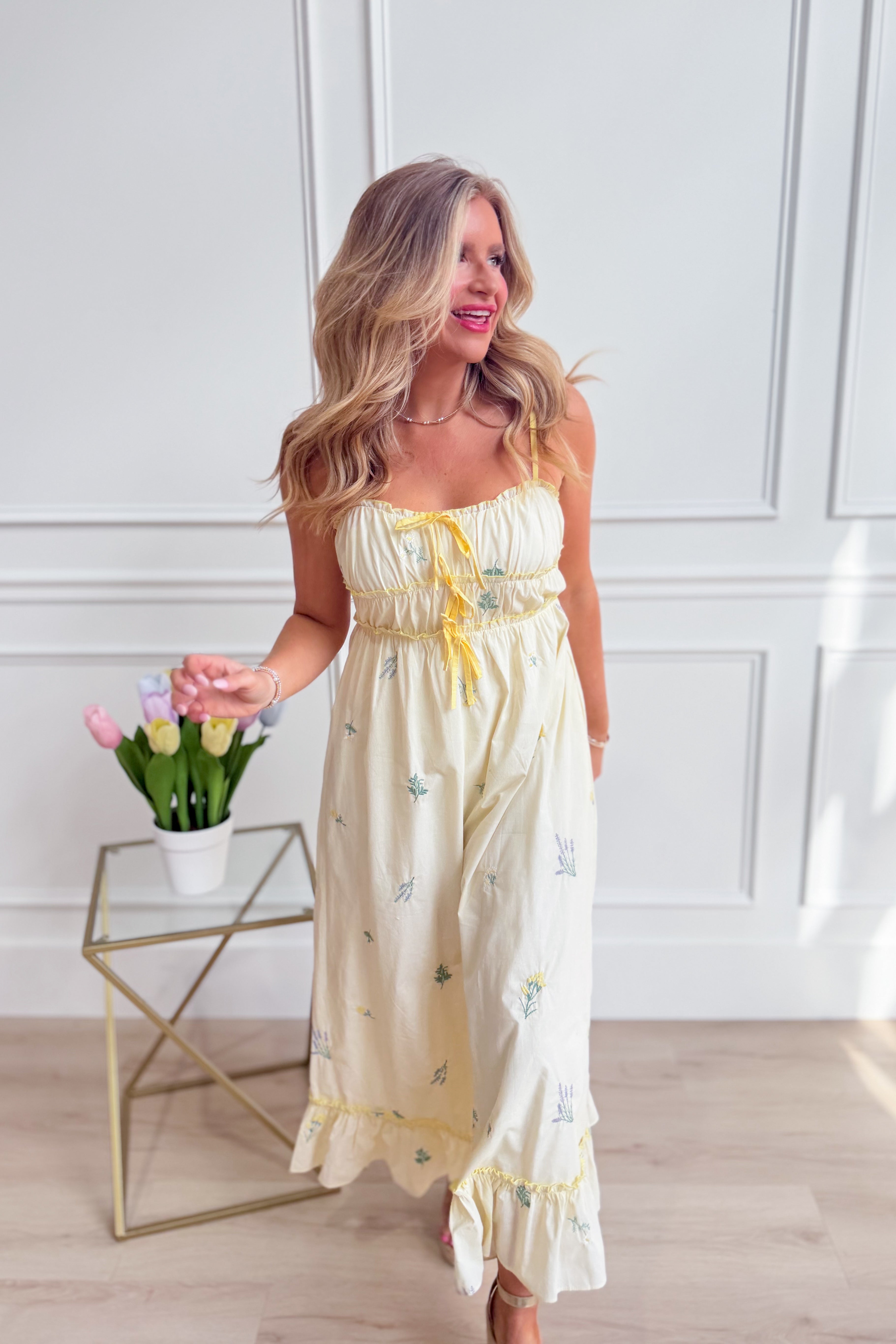 Avery triple bow floral midi dress by WISHLIST featuring a fitted bodice, flowy skirt, and vibrant floral pattern.