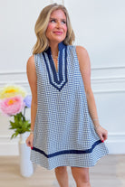 Corinne plaid sleeveless dress by ENTRO featuring a stylish plaid pattern, fitted bodice, and flowy skirt for dressy occasions.