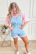 Peach Love Holly polka dot denim overall romper, featuring adjustable straps and front pockets, worn by a model.