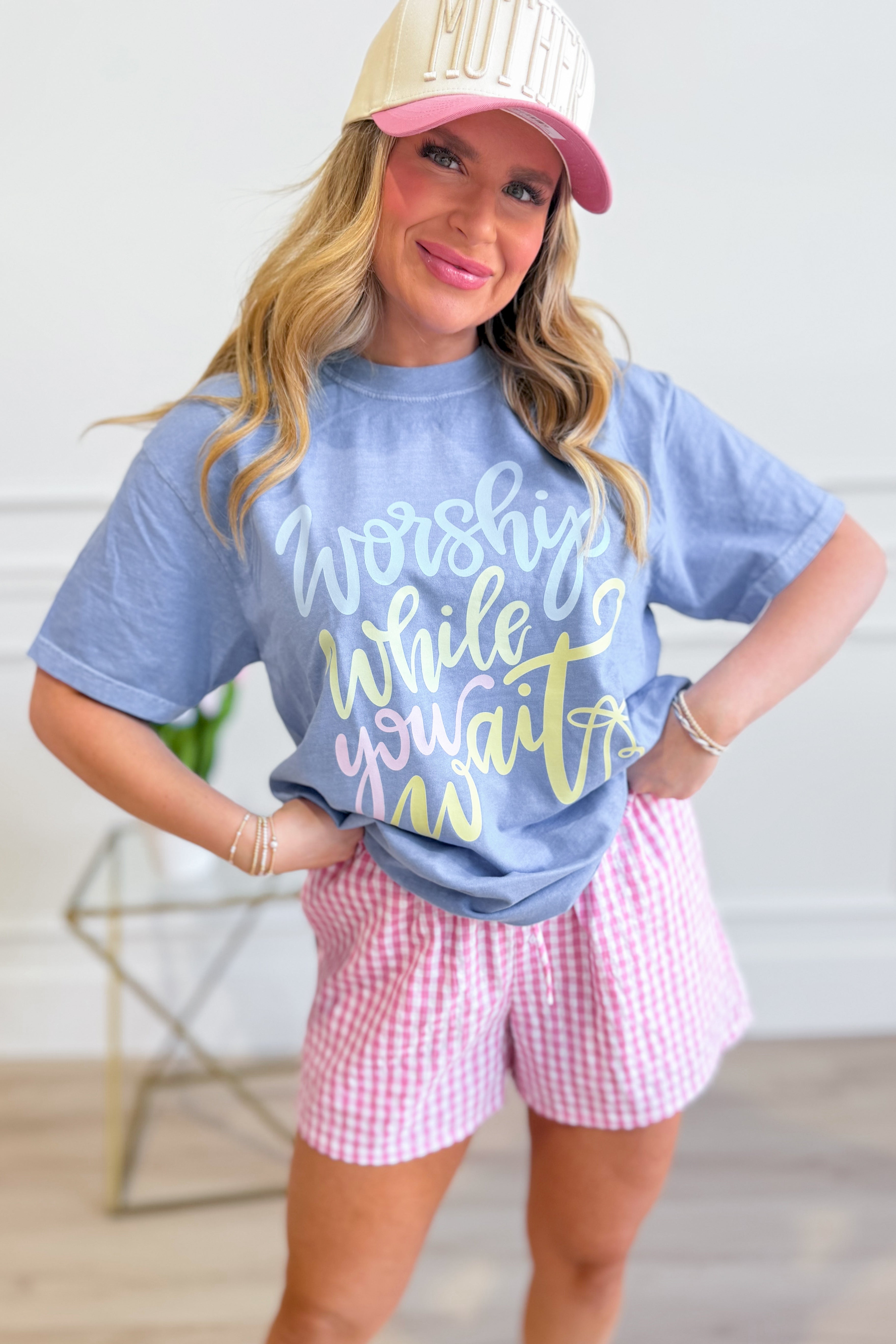 DASH FORWARD Worship While You Wait graphic T-shirt featuring bold text and modern design on a casual black tee.