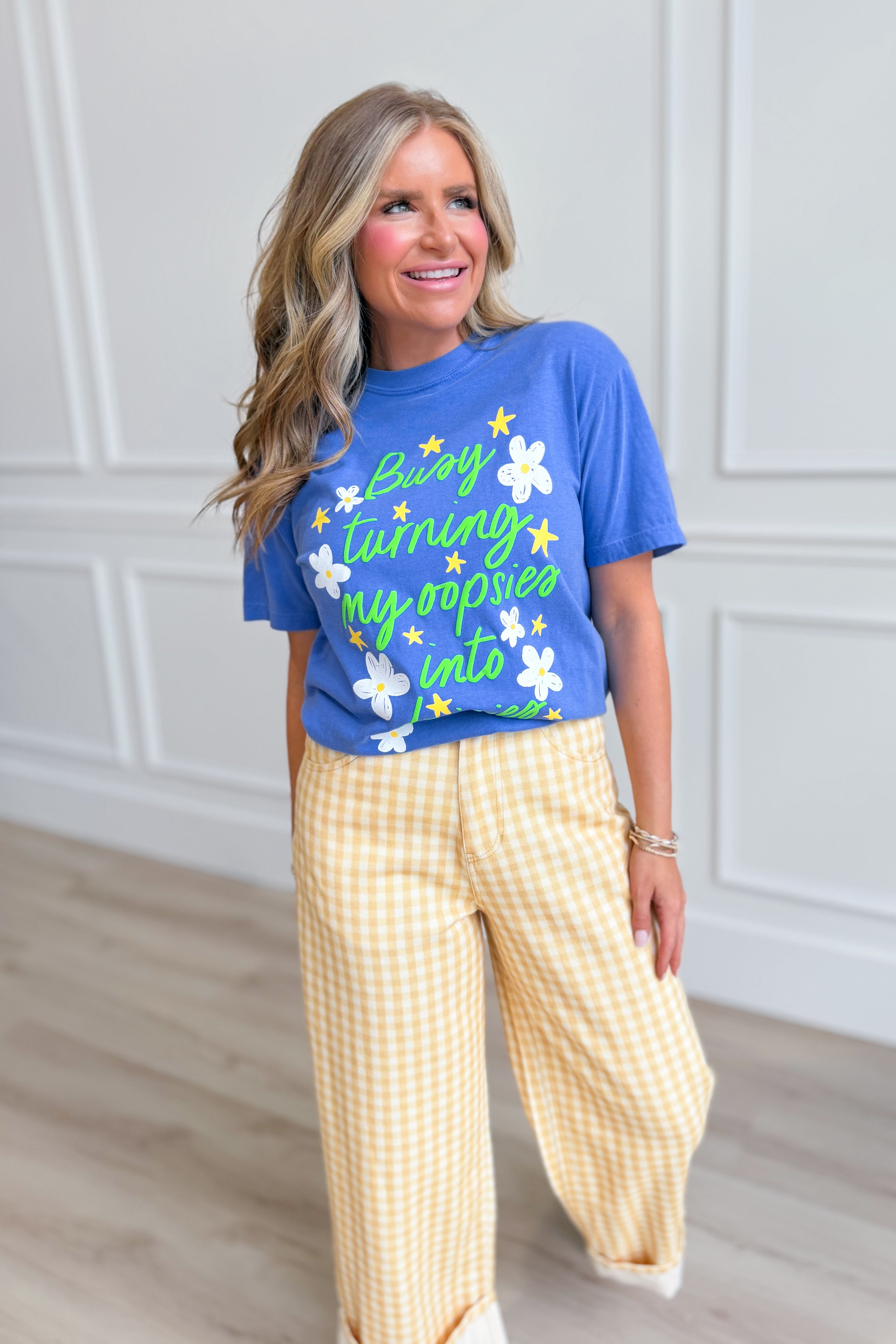 Pink graphic T-shirt from POPPY & PINE's 117 Graphic Tees collection featuring playful "Oopsies Into Dasies" design.