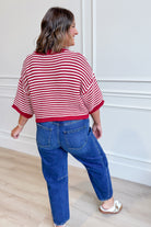 Red striped oversized sweater top by PEACH LOVE, featuring half sleeves and a relaxed fit, perfect for fall styling.