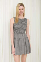 Liz Black Gingham Smocked Sleeveless Dress by BLU PEPPER, showing a stylish black and white gingham dress with smocked bodice and sleeveless design.