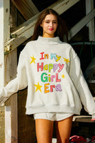Pink "In My Happy Girl Era" BUCKET LIST graphic sweatshirt with long sleeves and casual fit, displayed on a hanger.