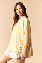 Yellow striped lettuce trim casual top by PEACH LOVE, featuring a relaxed fit and stylish design, shown on a model.