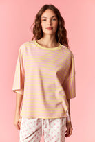 Peach Love Rudy striped relaxed casual top with long sleeves and a soft fabric, displayed on a hanger.