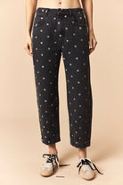 Betsy Polka Dot Denim Ankle Jeans by PEACH LOVE, featuring navy blue fabric with white polka dots and a slim fit ankle cut.