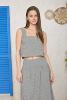 BLU PEPPER Marian plaid sleeveless top with casual style, featuring a red and black checkered pattern and fitted design.