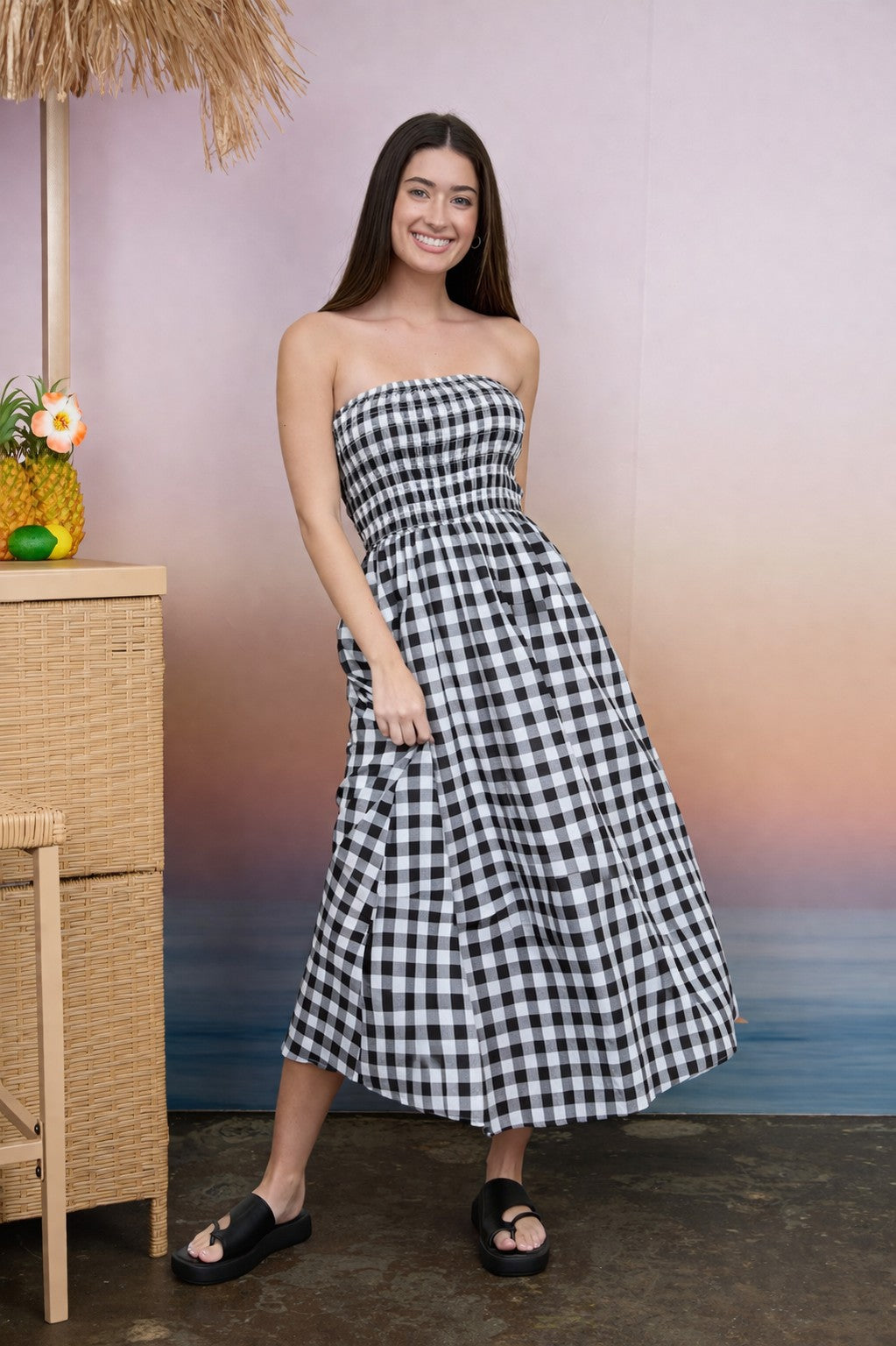 BLU PEPPER Dave plaid strapless midi dress displayed on a hanger, showcasing its stylish design and pattern.