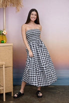 BLU PEPPER Dave plaid strapless midi dress displayed on a hanger, showcasing its stylish design and pattern.