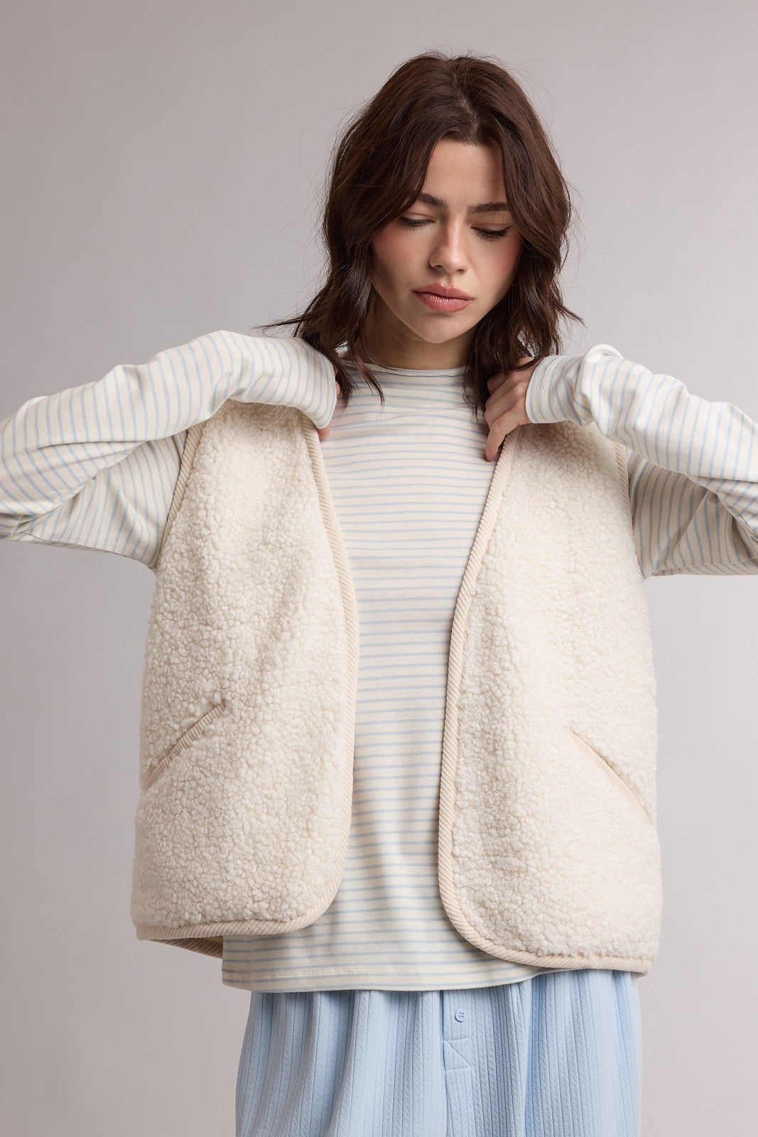 Wishlist Cannon Ecru Sherpa Sleeveless Vest, 140 outerwear, showing a cozy, sleeveless sherpa vest in ecru with a high collar and textured fabric.