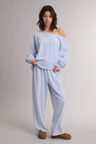 WISHLIST Sia striped one-shoulder pant set with 156 pants, featuring bold stripes and a stylish one-shoulder design.
