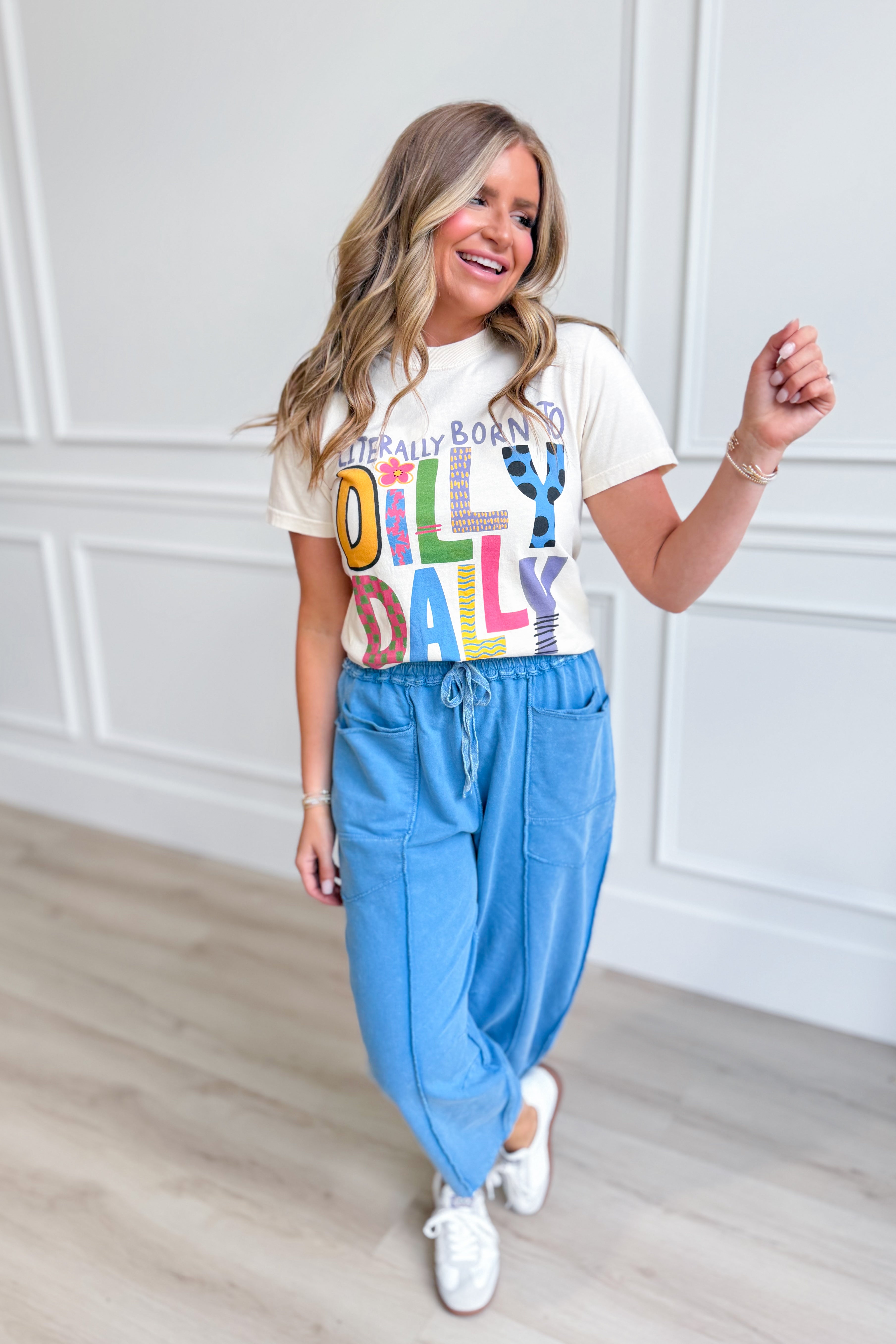 POPPI & PINE "Literally Born To Dilly Dally" graphic T-shirt with bold text on a casual men's T-shirt.