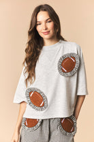 Laurel Gingham Ruffled Football Patched Top by PEACH LOVE, casual 105 top with ruffles and patch details, worn by a model.