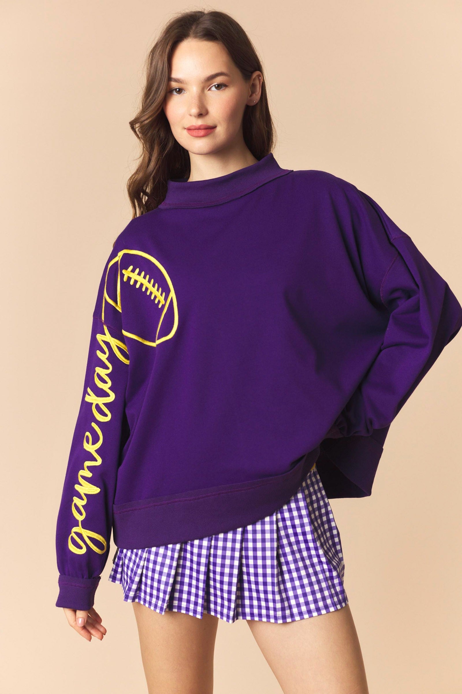 Lexie Purple Game Day Pullover from PEACH LOVE, featuring a 137 graphic sweatshirt design with vibrant purple color.