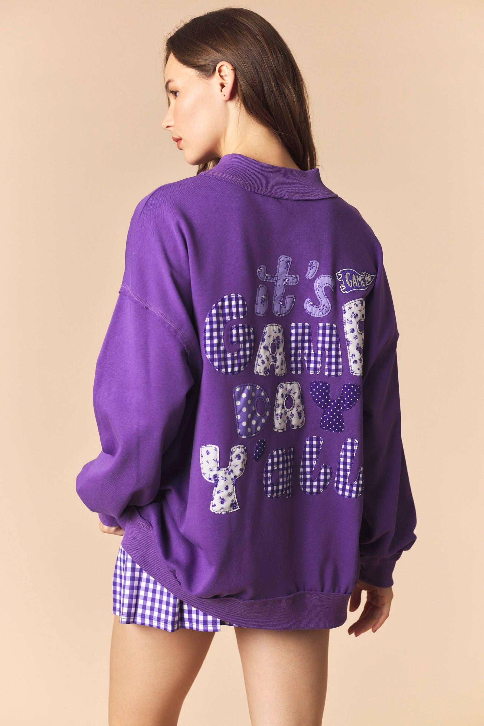 Purple Cynthia Game Day Pullover from PEACH LOVE, 137 graphic sweatshirt with team logo and comfortable fit.