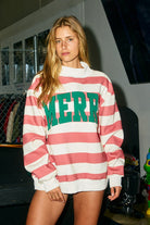 Embroidered Merry striped mock neck sweatshirt from BUCKET LIST, featuring colorful festive embroidery on a cozy graphic sweatshirt.