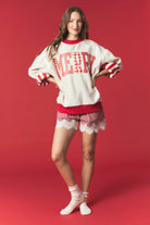 Reversible red and striped graphic sweatshirt from PEACH LOVE featuring festive holiday design and cozy fit.