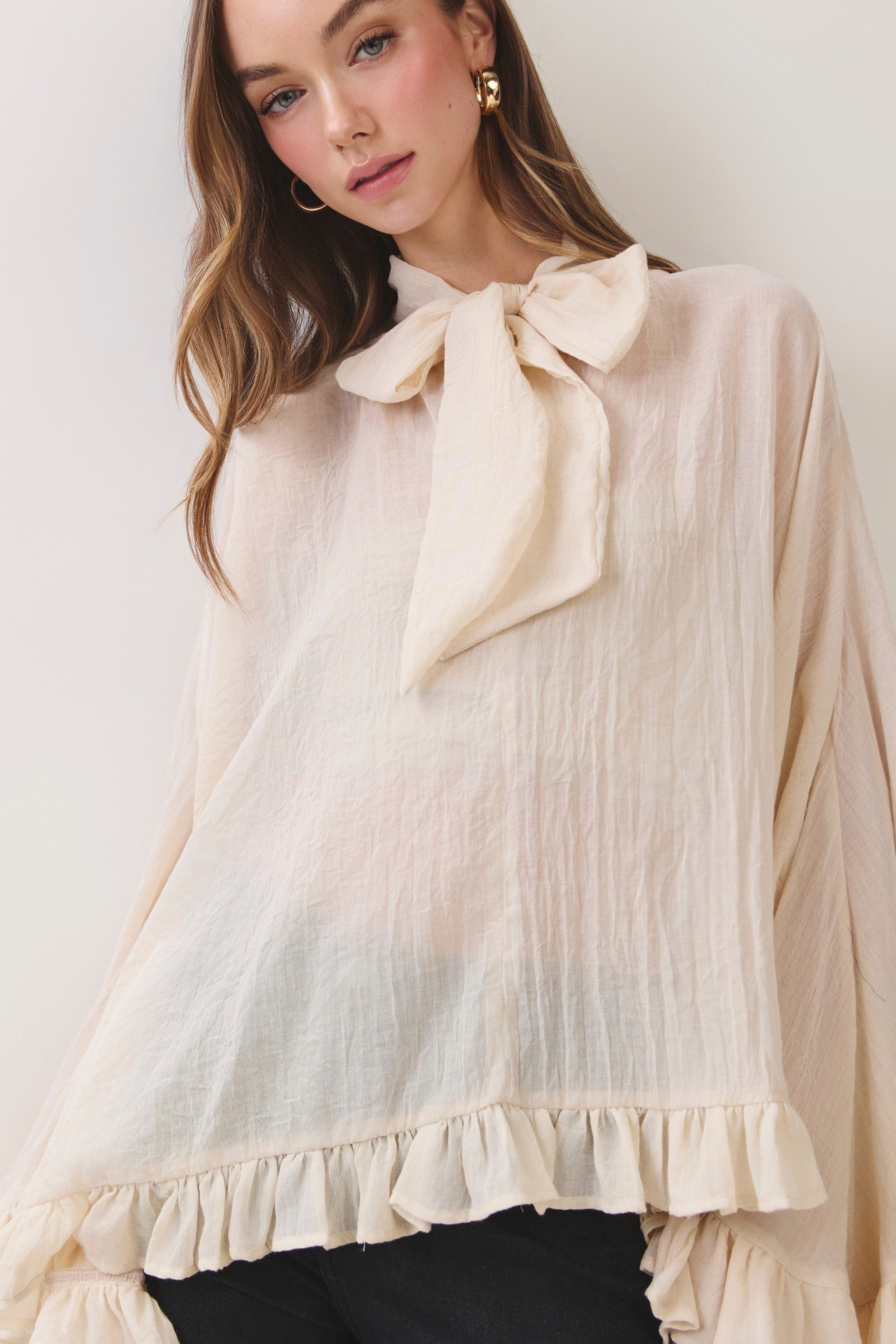 TCEC Kimmie Tie Neck Ruffle Top in a stylish, flowy design with tie-neck details and ruffled sleeves, perfect for dressy occasions.