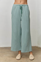 Roland Seafoam Gingham Drawstring Wide Leg Pant by BAEVELY, featuring a seafoam green and white gingham pattern with a relaxed fit.