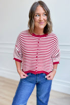 Red striped oversized sweater top by PEACH LOVE with half sleeves, casual fall style, featuring a relaxed fit and cozy knit fabric.