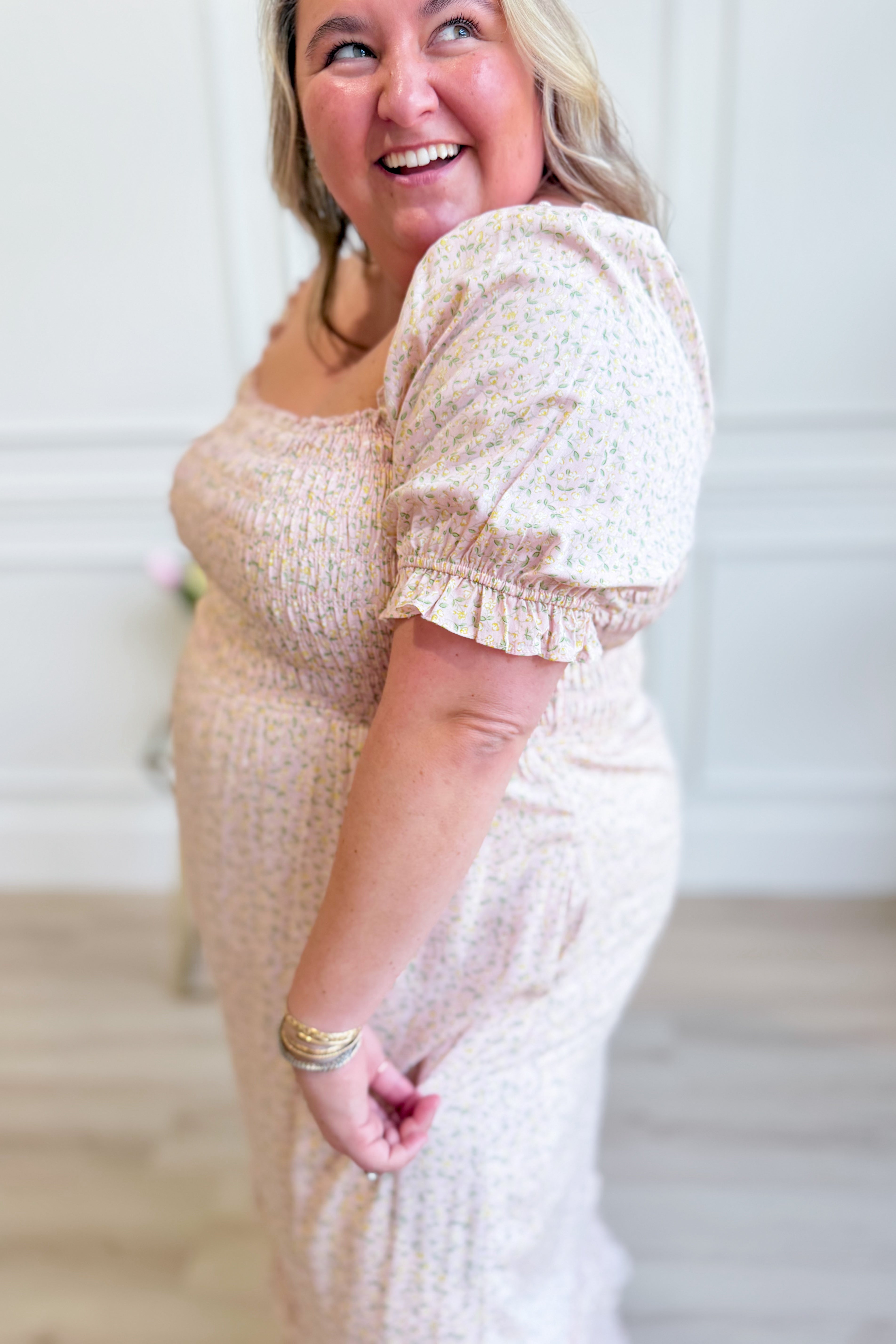 IN LOOM Luna smocked floral maxi dress displayed on a hanger, showcasing its flowy fabric and vibrant floral pattern.