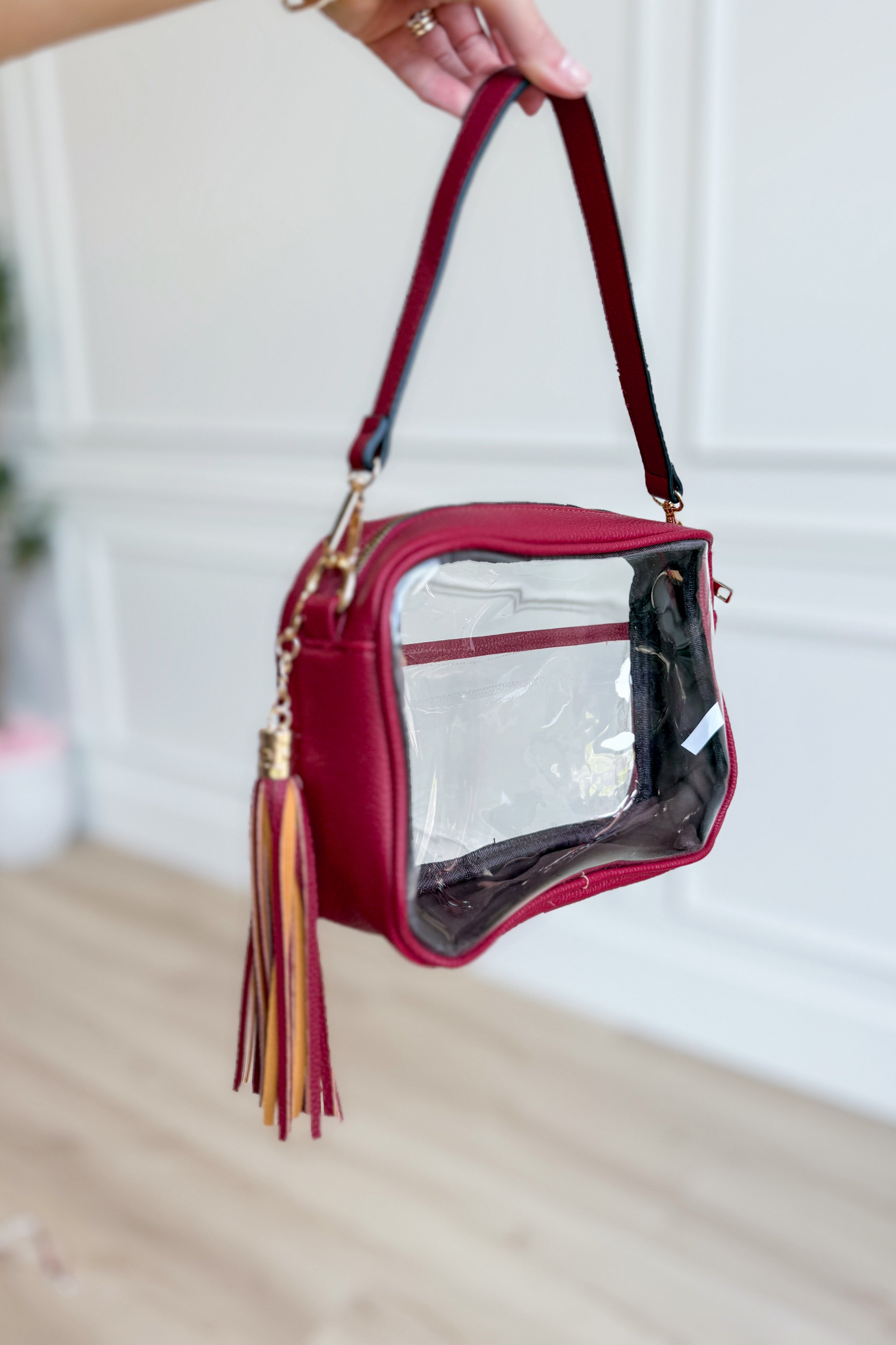 Burgundy clear stadium crossbody bag by QUEENS DESIGNS, featuring transparent design and adjustable strap for casual occasions.