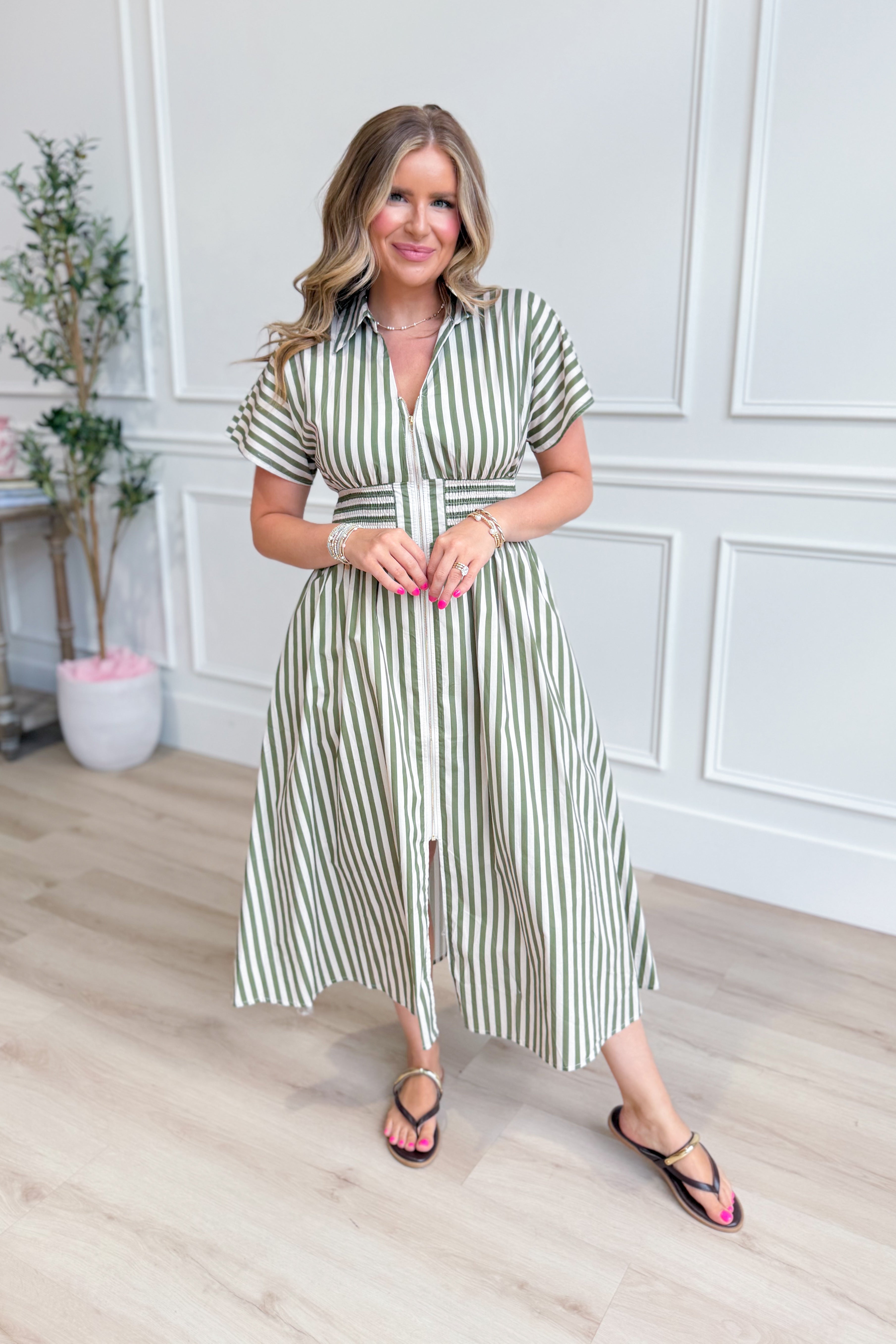 Kristen Olive Striped Zip-Up Midi Dress by ENTRO, featuring a fitted silhouette with green and white stripes and a front zipper.