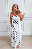 Laney Polka Dot Maxi Dress by THINGS BETWEEN, featuring a flowing silhouette and classic polka dot pattern, perfect for dressy occasions.