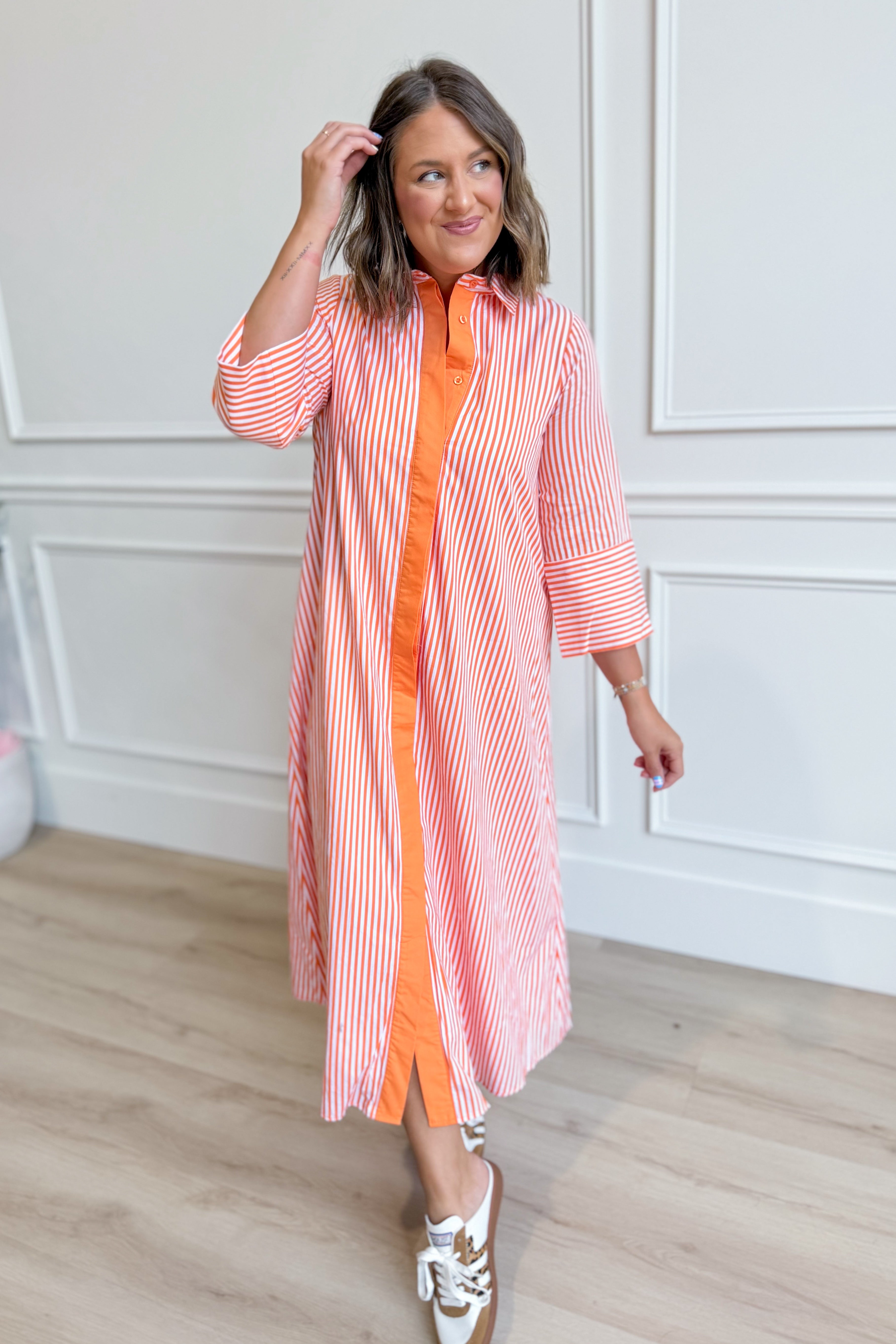 TCEC Aly striped button-down midi dress with long sleeves and a fitted waist, featuring a chic, classic pattern.