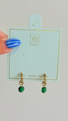 Enewton .5mm Classic Birthstone Huggie earrings featuring a delicate gold hoop with a small birthstone accent.