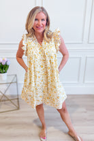 Entro Mindy floral flutter sleeve dress featuring a vibrant floral pattern and elegant flutter sleeves, perfect for dressy occasions.