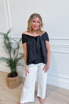 TCEC Oneita bow accented off-the-shoulder dressy top in black with elegant bow detail on the shoulder.