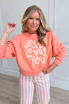 Smiley Jesus Loves You graphic sweatshirt by POPPY & PINE featuring a cheerful smiley face and positive message on soft fabric.