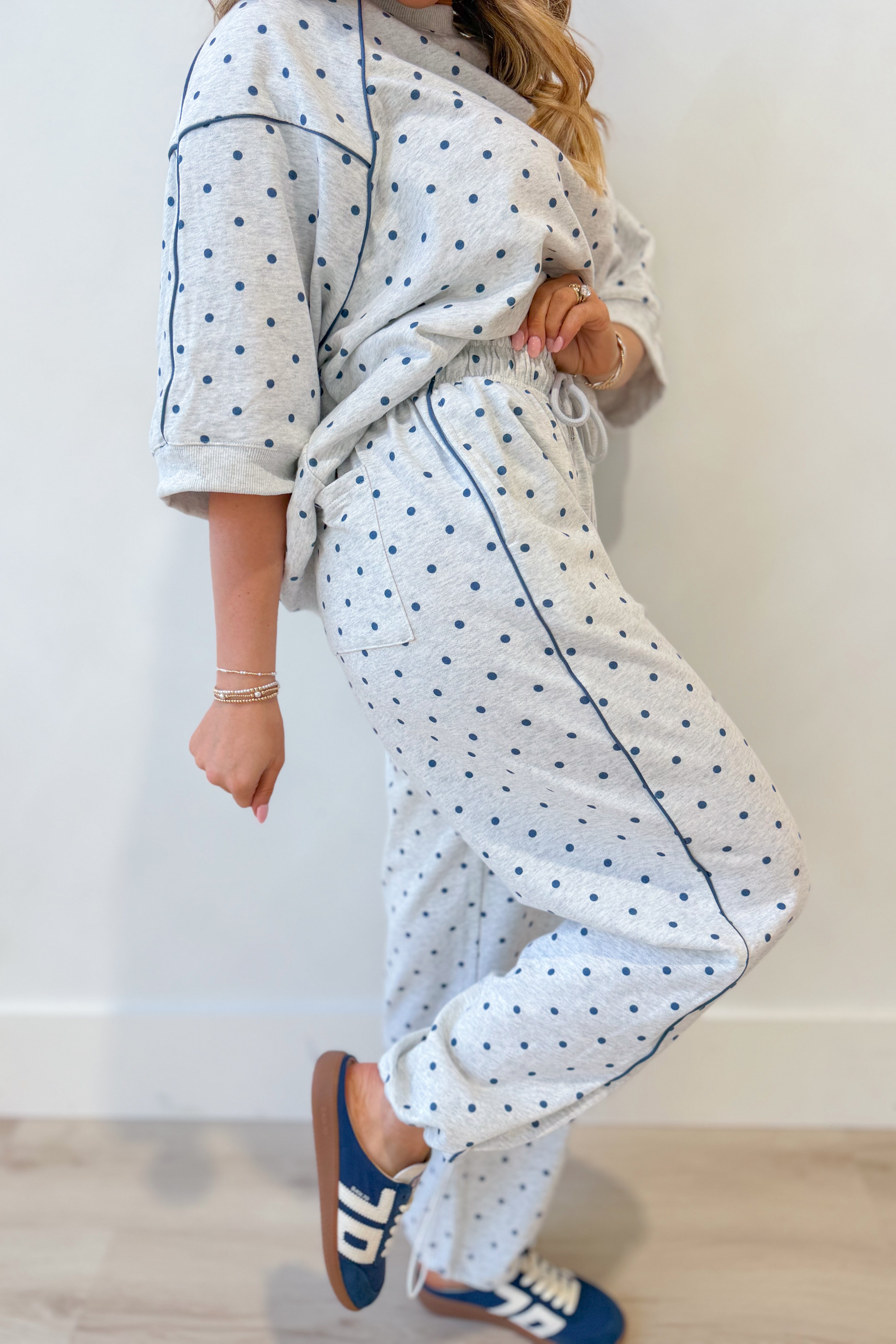 Frederick Grey Polka Dot French Terry Track Pants by PEACH LOVE, with elastic waistband and relaxed fit, shown in a casual setting.