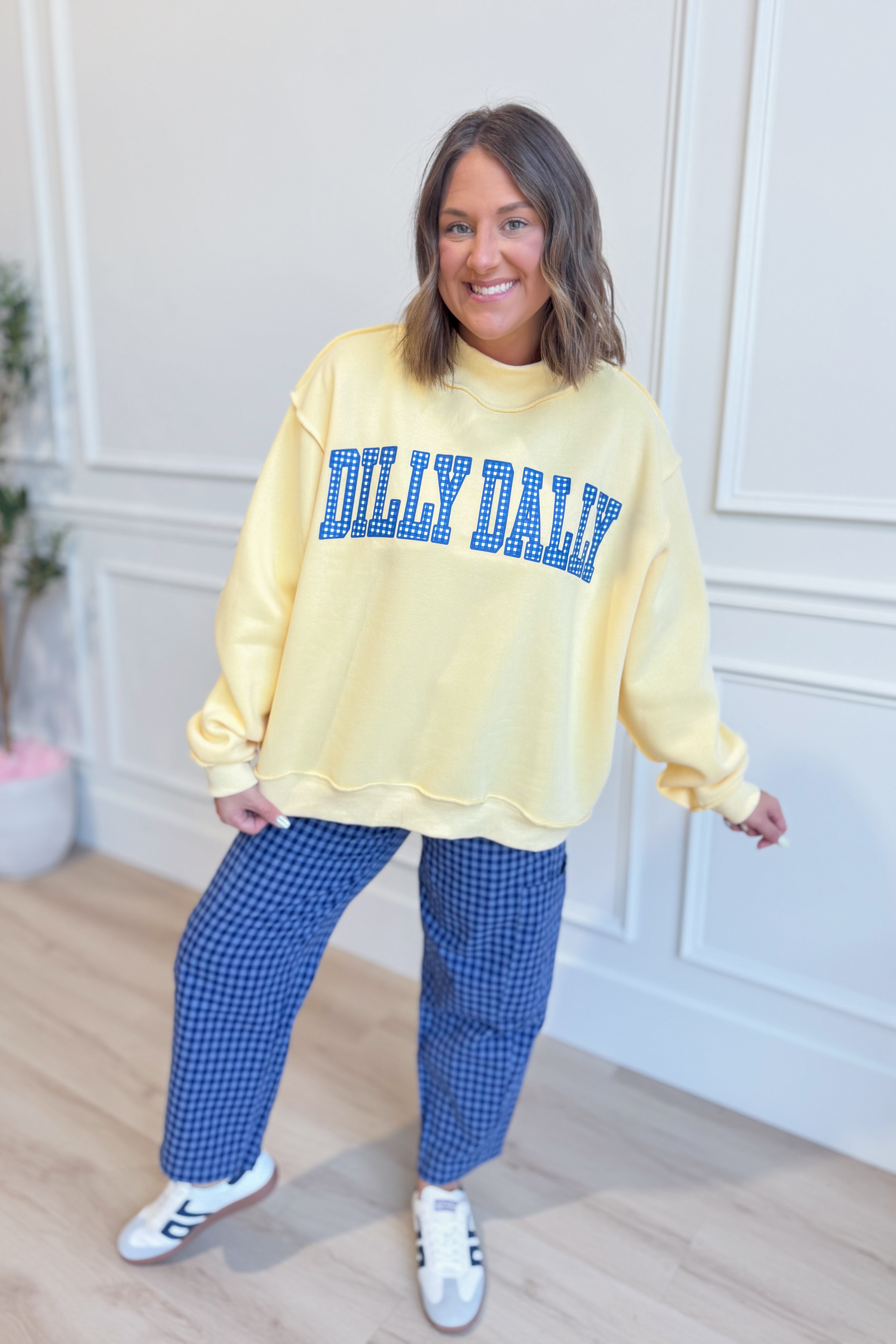 Reversible mock neck sweatshirt from BUCKET LIST with colorful “Lolly Gag Dilly Dally” graphic design, casual and cozy fit.