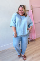 Baevly Lauren button-down cardigan top in a spring sweater style, shown in a soft, light-colored fabric with button details.