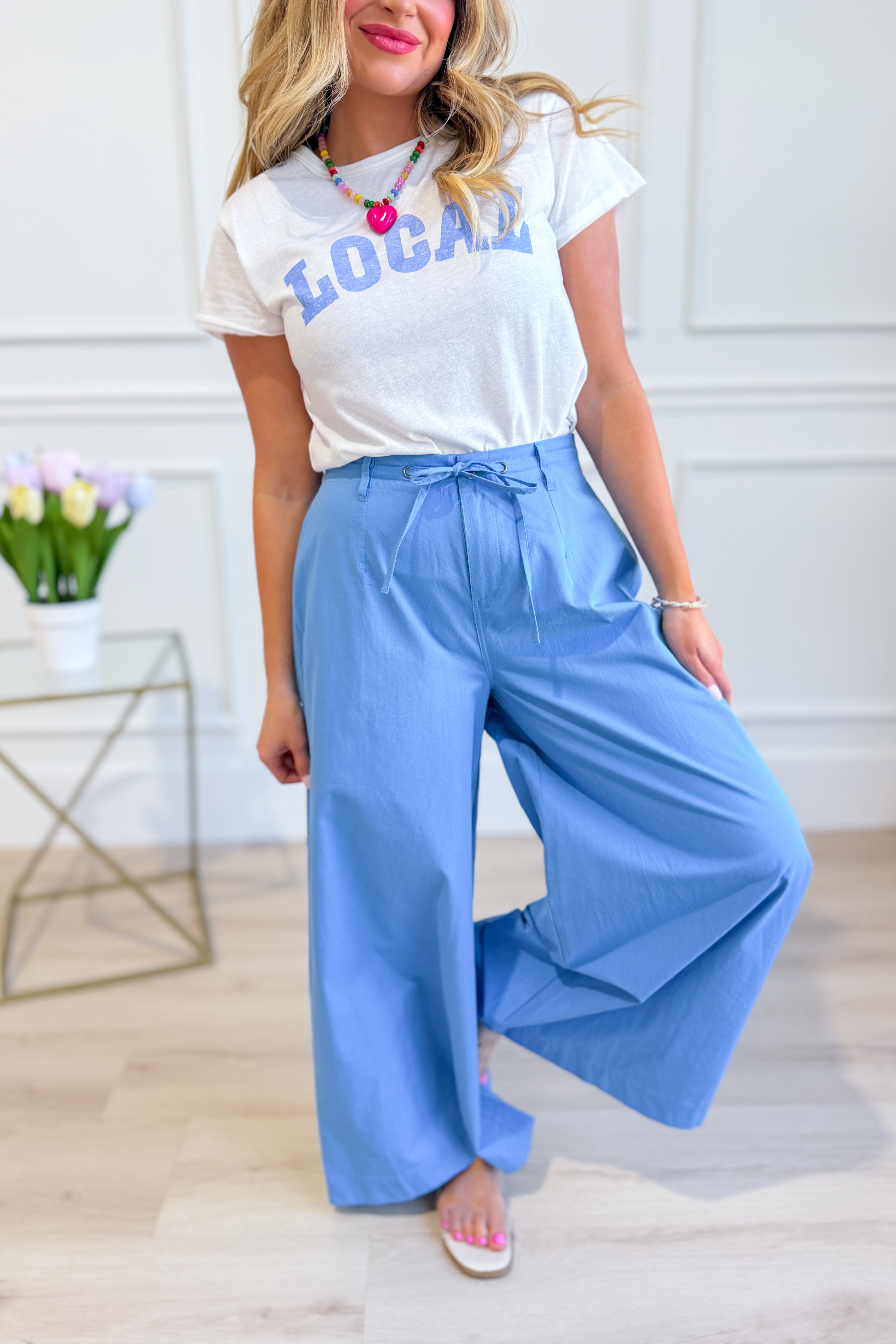 WISHLIST Reese wide-leg drawstring pants shown in beige with relaxed fit and elastic waistband on a model.