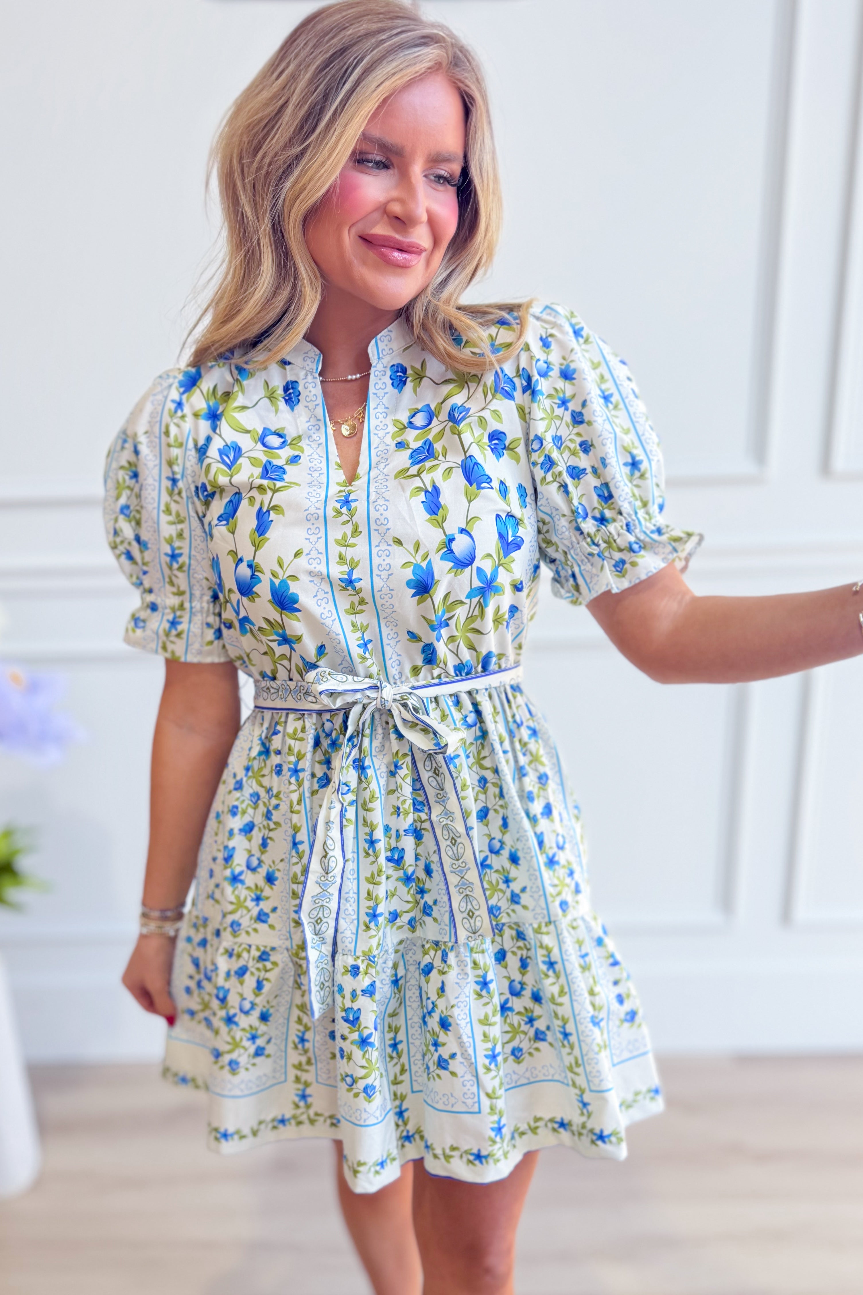 Elegant Bella floral printed tie waist dress by EE:SOME, featuring a flowy silhouette and vibrant floral pattern.