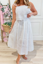 Nikki tiered midi skirt by ENTRO featuring layered fabric and a flowing design, shown in a stylish black color.